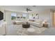 Living room featuring white furniture, modern ceiling fan, large windows and a rug at 3303 Kayak Way, Orlando, FL 32820