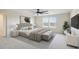 This main bedroom features neutral decor, a ceiling fan, and plenty of natural light at 3303 Kayak Way, Orlando, FL 32820