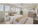 This main bedroom features a bed, a dresser, two windows, and neutral decor at 3303 Kayak Way, Orlando, FL 32820