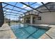 Backyard pool with dark metal screen and patio with ceiling fan, perfect for outdoor relaxation and entertaining at 3303 Kayak Way, Orlando, FL 32820