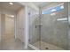 This shower features glass walls, tile, and a window allowing plenty of natural light at 3303 Kayak Way, Orlando, FL 32820