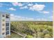 Scenic aerial view of the community, showing lush trees, a boardwalk, and marsh views at 5300 S Atlantic Ave # 6-501, New Smyrna Beach, FL 32169