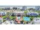 Aerial view of the community showcasing amenities, pool, tennis courts, and nearby beach at 5300 S Atlantic Ave # 6-501, New Smyrna Beach, FL 32169