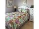 Stylishly decorated bedroom with floral bedding, tile flooring, and ample natural light at 5300 S Atlantic Ave # 6-501, New Smyrna Beach, FL 32169