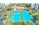 Community offers blue tennis courts with lush landscaping near the pool and amenity center at 5300 S Atlantic Ave # 6-501, New Smyrna Beach, FL 32169