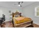 Bedroom with wooden bed frame, work area, and hardwood floors at 733 Clifford Dr, Orlando, FL 32804