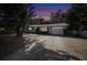 House exterior at dusk, featuring a gray exterior and attached garage at 924 Beard Ave, Winter Park, FL 32789