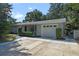 Ranch style home with a gray exterior, attached garage, and landscaping at 924 Beard Ave, Winter Park, FL 32789