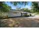 House exterior showcasing a gray-toned facade and well-maintained lawn at 924 Beard Ave, Winter Park, FL 32789