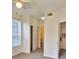 Bright bedroom with a ceiling fan, large window, closet, and an attached bathroom at 13103 Mulberry Park Dr # 817, Orlando, FL 32821