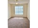 Bright, empty bedroom with a large window and ceiling fan, ready for a new owner at 13103 Mulberry Park Dr # 817, Orlando, FL 32821