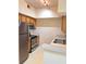Cozy kitchen featuring stainless steel appliances and light wood cabinetry at 13103 Mulberry Park Dr # 817, Orlando, FL 32821