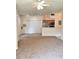 Spacious living room adjacent to the kitchen with multiple closets and neutral carpeting at 13103 Mulberry Park Dr # 817, Orlando, FL 32821