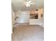 Spacious living room adjacent to the kitchen with multiple closets and neutral carpeting at 13103 Mulberry Park Dr # 817, Orlando, FL 32821