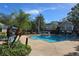 Community pool with lounge chairs and well-maintained landscaping at 13103 Mulberry Park Dr # 817, Orlando, FL 32821
