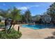 Community pool with lounge chairs and umbrellas at 13103 Mulberry Park Dr # 817, Orlando, FL 32821