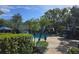 Community pool with lounge chairs and umbrellas at 13103 Mulberry Park Dr # 817, Orlando, FL 32821