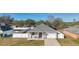 Aerial view showing a house with a gray roof and a fenced-in backyard at 1460 3Rd Ave, Deland, FL 32724