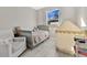 bedroom with crib, chair, and play tent at 1460 3Rd Ave, Deland, FL 32724