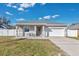 Newly constructed home with a gray exterior, white garage door, and landscaped yard at 1460 3Rd Ave, Deland, FL 32724