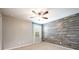 Bedroom with wood-look accent wall and ceiling fan at 1601 Blue Grass Blvd, Deland, FL 32724