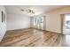 Bright living room featuring hardwood floors and sliding glass doors at 1601 Blue Grass Blvd, Deland, FL 32724