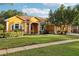 Beautiful yellow single-Gathering house with a well-manicured lawn and landscaping at 20575 Nettleton St, Orlando, FL 32833