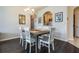 Dining room featuring a wooden table, white chairs, and a chandelier at 2785 Almaton Loop # 305, Kissimmee, FL 34747