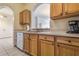 Kitchen area featuring wooden cabinetry and laminate countertops at 2785 Almaton Loop # 305, Kissimmee, FL 34747