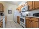 Efficient kitchen featuring wood cabinets and white appliances at 2785 Almaton Loop # 305, Kissimmee, FL 34747