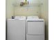 Functional laundry room featuring a washer, dryer, and wire shelving for storage at 2785 Almaton Loop # 305, Kissimmee, FL 34747