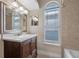 Bathroom features a dark wood vanity with marble countertop, a window, and shower at 2801 Ripton Ct, Orlando, FL 32835