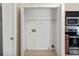 Spacious closet with shelving and hookups for laundry appliances, offering convenience and organization at 2801 Ripton Ct, Orlando, FL 32835