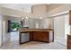Open-concept kitchen with stainless steel dishwasher and a view of the living area and outdoor deck at 2801 Ripton Ct, Orlando, FL 32835