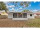 View of home's back and screened porch at 3629 Peaceful Pl, Orlando, FL 32810