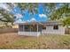 View of home's back and screened porch at 3629 Peaceful Pl, Orlando, FL 32810