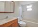 Bathroom with tub, toilet and wood vanity at 3629 Peaceful Pl, Orlando, FL 32810