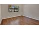 Simple bedroom with wood-look flooring and window at 3629 Peaceful Pl, Orlando, FL 32810