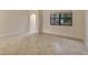 Spacious living area with tile floors and access to hallway at 3629 Peaceful Pl, Orlando, FL 32810