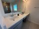 Bathroom with double vanity and quartz countertops at 6635 Tempo Way, Mascotte, FL 34753