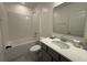 Main bathroom with shower/tub combo and gray vanity at 6635 Tempo Way, Mascotte, FL 34753