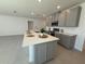 Modern kitchen with an island, gray cabinets, and white countertops at 6635 Tempo Way, Mascotte, FL 34753