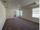 Spacious main bedroom with carpet flooring and en-suite bathroom access at 6635 Tempo Way, Mascotte, FL 34753