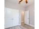 Bright bedroom featuring a ceiling fan, closet, and an ensuite bathroom at 0 Paddock St, Orlando, FL 32833