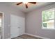Neutral bedroom with wood floor, window and double door closet at 0 Paddock St, Orlando, FL 32833