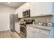 Modern kitchen featuring stainless steel appliances, granite countertops, and white cabinets at 0 Paddock St, Orlando, FL 32833