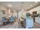 Eat-in kitchen and dining room featuring an island with bar seating, stainless appliances, and modern finishes at 0 Paddock St, Orlando, FL 32833