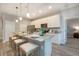 Modern kitchen featuring a granite-topped island with seating, stainless steel appliances, and white cabinetry at 0 Paddock St, Orlando, FL 32833