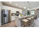 Well-lit kitchen with granite countertops, stainless steel appliances, and a breakfast bar with seating at 0 Paddock St, Orlando, FL 32833
