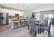 Open-concept kitchen featuring stainless steel appliances, granite countertops, and a breakfast bar for casual dining at 0 Paddock St, Orlando, FL 32833